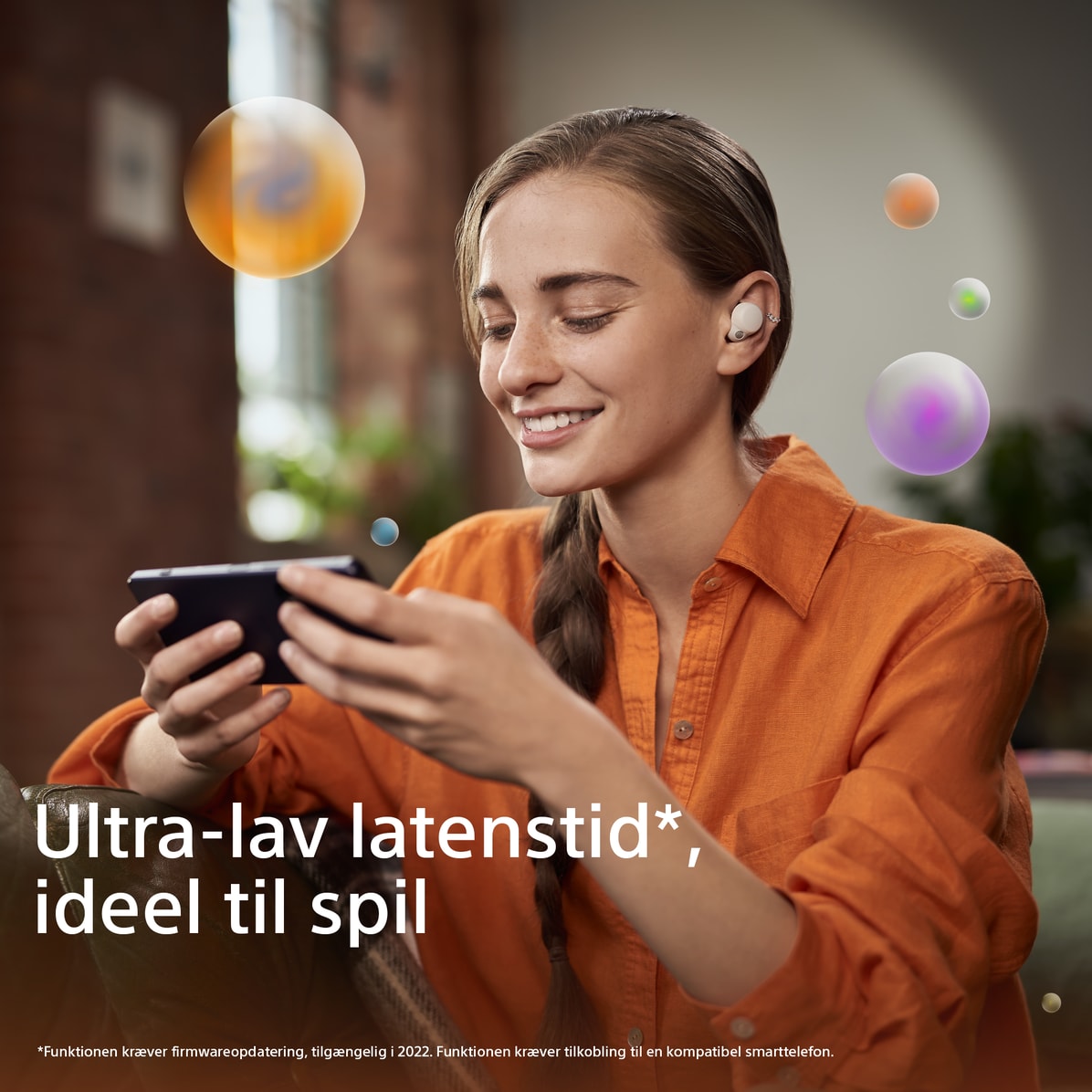 Linkbuds S - Woman in orange blazer looking at phone DK
