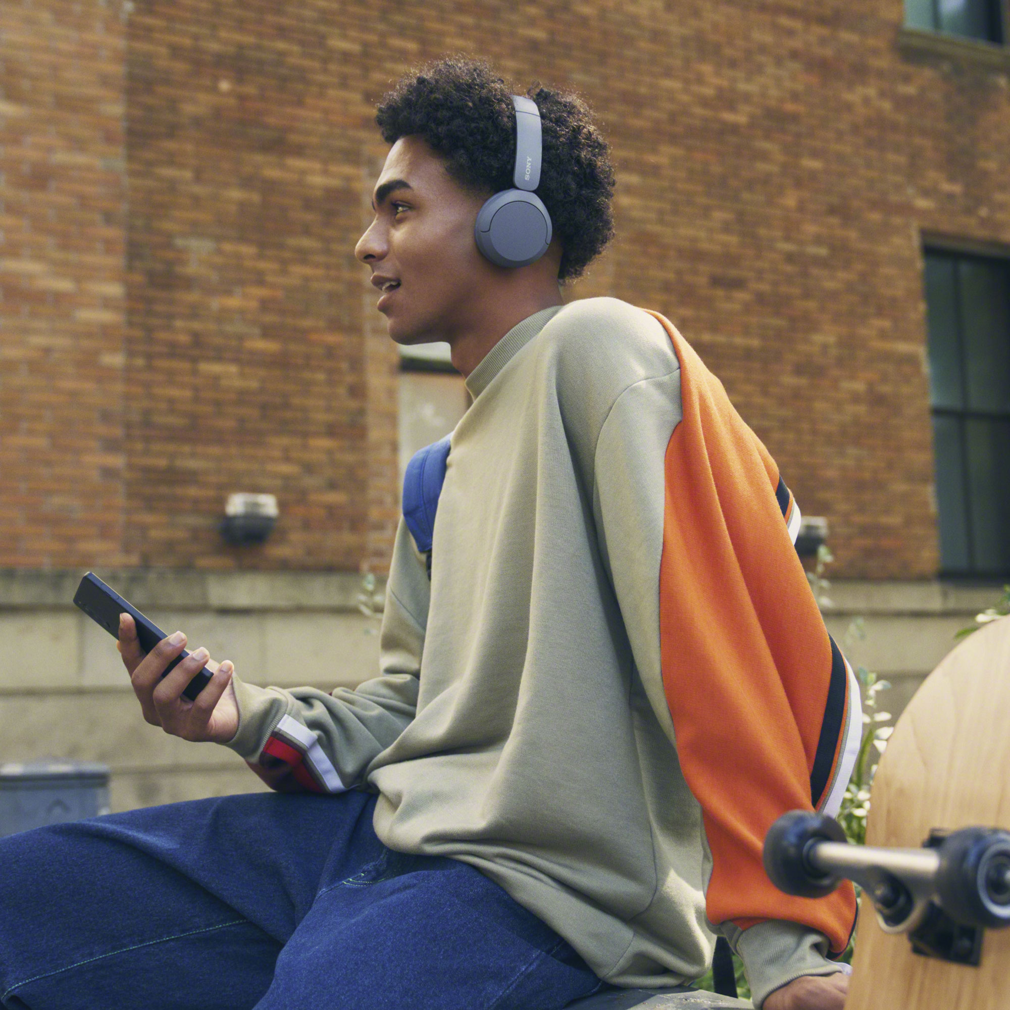 Boy wearing Sony WH-CH520 headphones and enjoying its Clear Call Quality