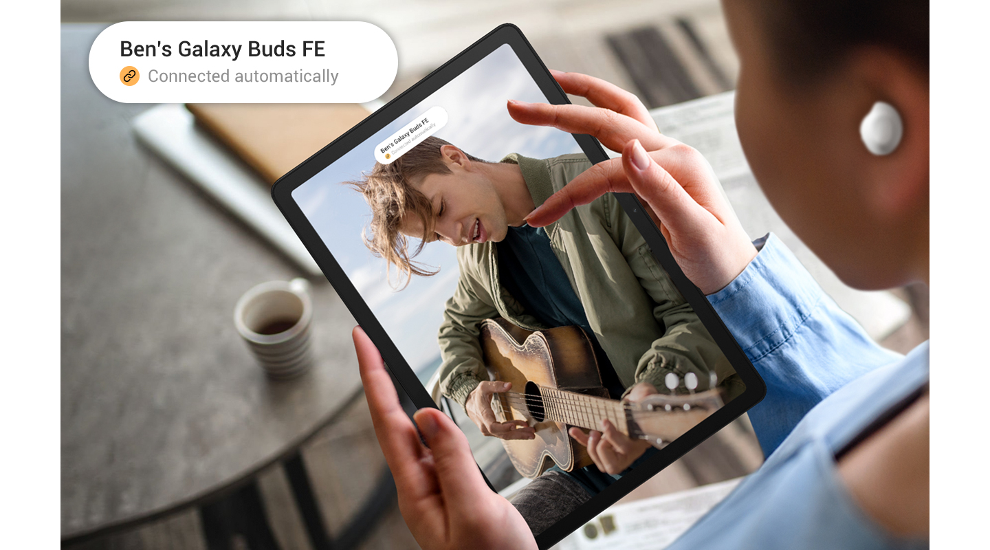 En person bruger Galaxy Tab A9 med Galaxy Buds FE i ørerne