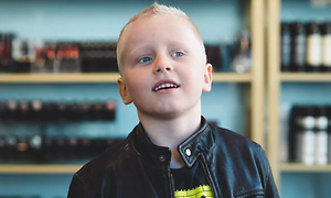 Smilende dreng med en frisk, ny frisure