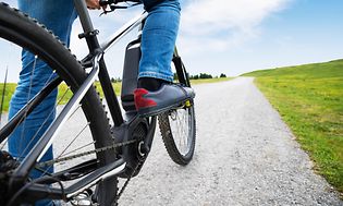 Person på en elcykel ude på landet.