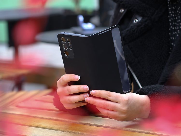 Samsung Galaxy-telefon med cover i hånden på kvinde