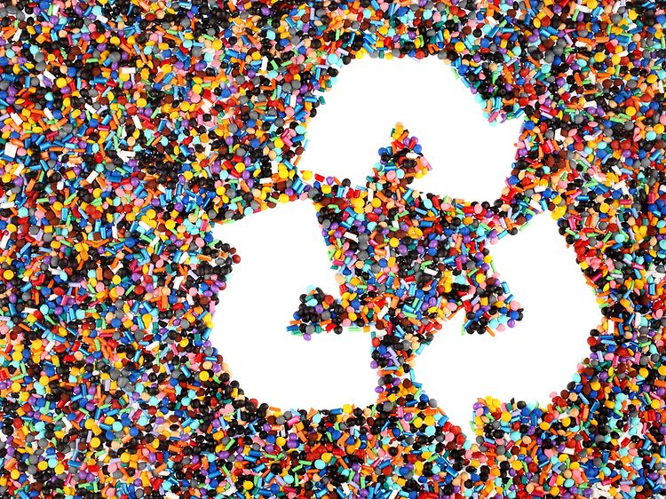Plastic pieces and a recycling logo