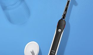Oral-B Pro 2 elektrisk tandbørste og oplader på en blå overflade