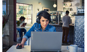 A woman with her Lenovo Legion in a café