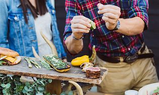 Outdoor kitchen - a man seasoning meat and vegetables