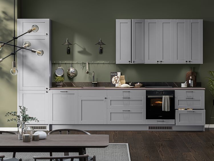 Kitchen with grey cabinets against green wall