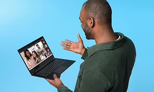 Man holding Windows 11 laptop