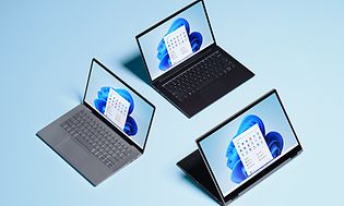 Tre bærbare computere på blå baggrund