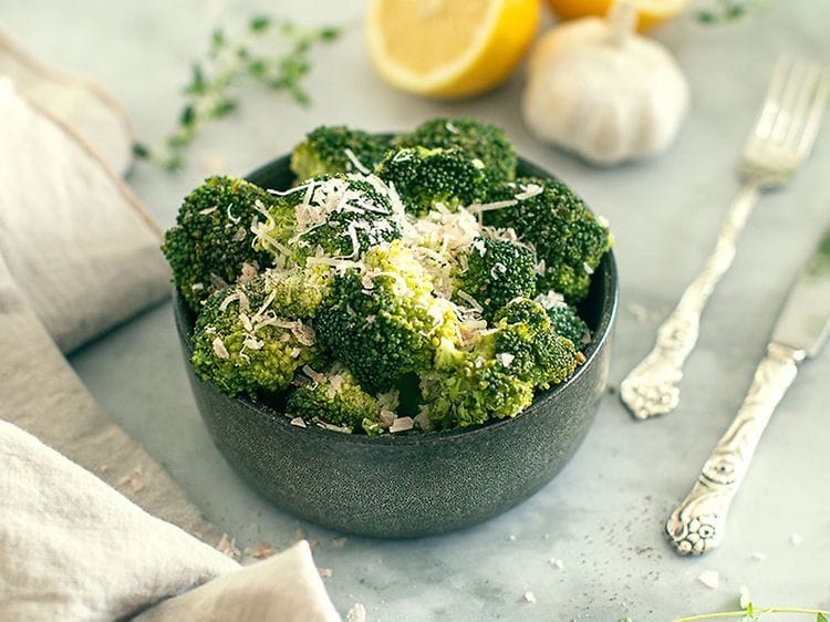 Bowl with broccoli on a dinner table