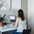 Woman sitting at her home office desk working on her laptop