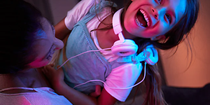 Woman and girl listening to music