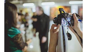 Person tager billede med et kamera med integreret blitz