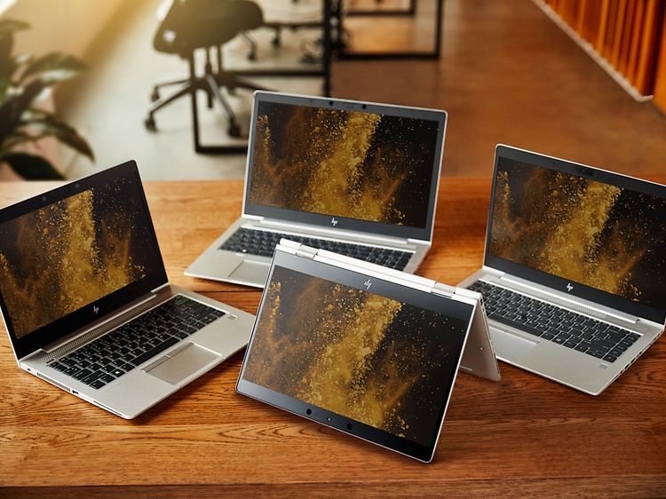 Fire HP EliteBook bærbare computere på et træbord