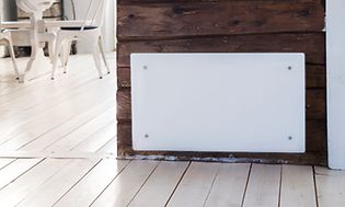 Panel heater on a wooden wall