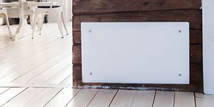 Panel heater on a wooden wall