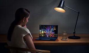 ZenBook 14 OLED - Kvinde, der bruger den på et bord