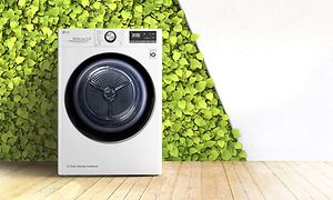 White dryer from LG standing in front of a green wall (1)