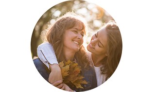 To smilende kvinder med efterårsblade