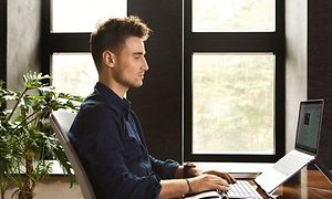 man-working-on-a-laptop-and-usin