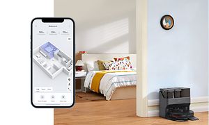 Smartphone og Roborock Max V Ultra i en dockingstation i baggrunden