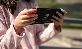 Nintendo: Nintendo Switch-konsol i hånden på pige