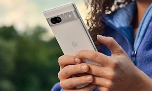 Woman holding a Google Pixel 7a in the rain