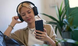 Young girl listening to music with Xperia 1 V and headphones