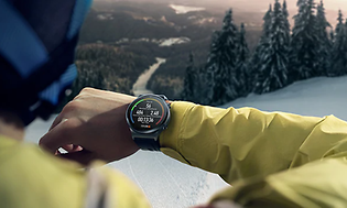 person looking at watch while jogging outdoors