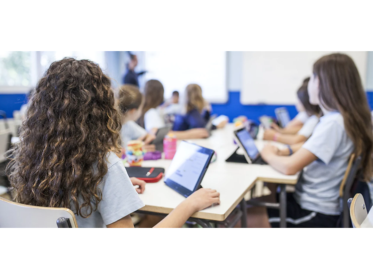 image of kids in a school with their tablets and computers