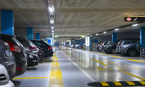 A lot of cars parked in a parking house